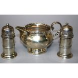 A pair of Queen Anne style "lighthouse" type silver peppers with bayonet fixed pierced covers.