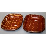 Two Victorian slipware baking dishes, one with wavy banded decoration the other with trellis slip.