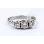 A diamond and platinum ring comprising three claw set brilliant cut diamonds with a total diamond