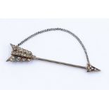 An Edwardian diamond set jabot pin in the form of an arrow, the fletching and arrow head set with