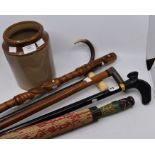A collection of walking sticks and canes to include: 9ct gold mounted ivory handle example