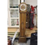 A 1930s oak eight day Grand Daughter clock, with three winder holes, Westminster chime, silvered