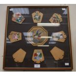 A framed montage of wooden love tokens, hand painted with floral scenes possibly made as