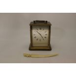 Late 20th Century brass mantle clock along with an ivory letter opener
