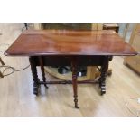A mid Victorian walnut Sutherland table, raised on four turned supports, united by a single turned