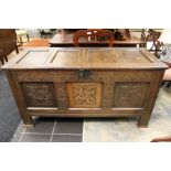 A 17th Century joined oak chest, four panelled lid, three panelled front with carved decoration,