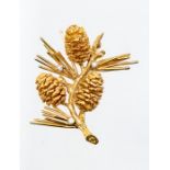 A 14ct rose gold and diamond brooch in the form a fur tree branch with pine cones, set with three