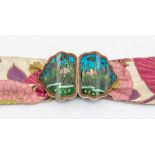An Art Nouveau enamelled base metal pair of buckles with abstract foliage decoration shaped edges (