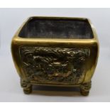 A Chinese cast planter, of square form, cast with dragon decoration to each side, raised on four