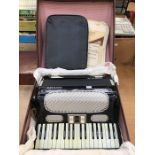 A Hohner Arietta IM Accordian, mid 20th Century, having three octaves, complete with carrying case