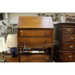 An Edwardian mahogany bureau, the fall front enclosing a fitted interior, two drawers to base, an
