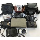 A collection of assorted cameras including an Olympus optical zoom with case, an Olympus digital