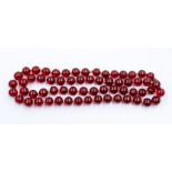 A cherry Bakelite single strand bead necklace, comprising round beads approx 13mm, strung