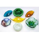 A collection of studio glass bowls and ashtrays