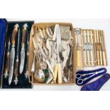 A collection of silver plated flatware including: Victorian antler handled boxed carving set,