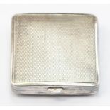 An art Deco silver compact, cushion shaped with engine turned decoration, approx 42mm x 42mm,