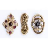 Three early 20th Century 9ct gold brooches, to include a Victorian garnet set brooch comprising a