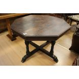 A Victorian oak octagonal breakfast table, raised on turned supports with a cross-stretcher to base,