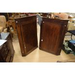 A George III mahogany hanging corner cupboard, fitted with a single door enclosing fitted shelves,