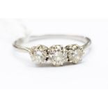 A 20th Century three stone diamond and platinum ring, comprising three brilliant cut diamonds,