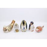 Five Royal Crown Derby paperweights including penguins, song thrush and pheasant, gold stoppers