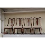 A set of four circa 1920's reproduction Queen Anne dining chairs with fiddle backs and pad feet