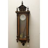 A late 19th Century walnut Vienna wall clock, eight day movement, weight driven, the pediment with