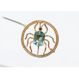 An early 1900's spider brooch, the 9ct rose gold circular open border inset with a spider, the