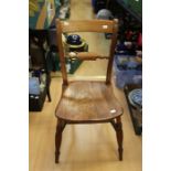 A 19th Century kitchen Windsor chair, elm seat, raised on turned legs