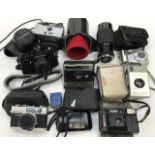 A collection of assorted cameras and lenses including Pentax MV1 with a Pentax M1:2 50mm lens,