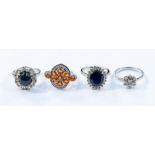 Four silver stone set rings to include a star sapphire and white topaz cluster ring, set to the