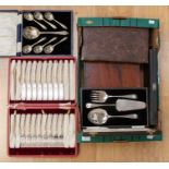 A box containing various cutlery sets, comprising cake knife and fork set, set of dessert spoons,