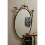 A Classical style gilt framed wall mirror with swag decoration, 78cm high, 98cm wide; together