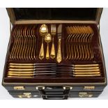A briefcase containing gold plated Royal Solingen canteen of cutlery along with a breifcase of