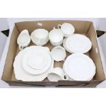 A Royal Crown Derby white part tea set comprising six cups, eleven saucers, six side plates, milk