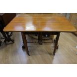 A Victorian oak Sutherland table, circa 1880, raised to each end on turned columns, 72cms high by