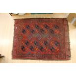 Three early to mid 20th Century red and blue ground rugs, hand knotted and woven (3) CR; worn A.F