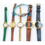 Gucci- a collection of ladies Gucci watches to include a white metal snaffle bangle watch along with