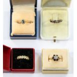 A collection of four 9ct gold rings to include an early 20th century ruby and diamond eternity ring,