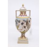 A Naples twin handled vase and cover depicting Putti in high relief.