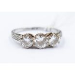 A diamond and platinum ring comprising three claw set brilliant cut diamonds with a total diamond