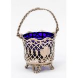 A Victorian swing handed sugar basket, wavy rim above openwork geometric boy on four scroll feet,