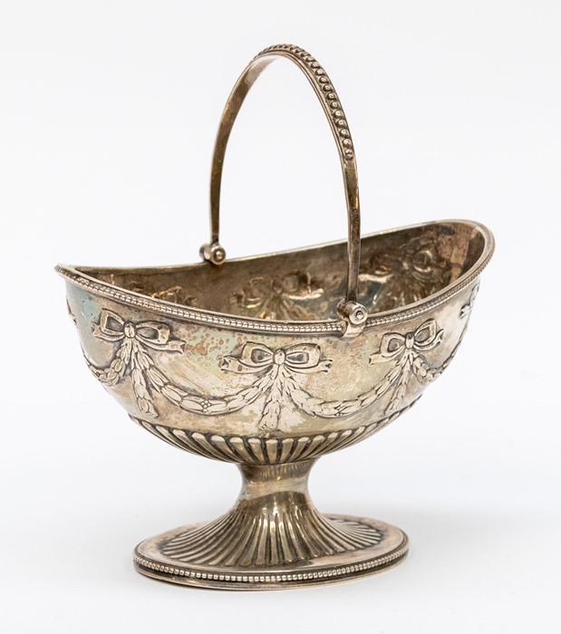 A Victorian silver Neo-Classical style sugar basket, swing handle above body chased with ribbon tied