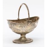 A Victorian silver Neo-Classical style sugar basket, swing handle above body chased with ribbon tied