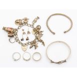 A collection of silver jewellery including a silver charm bracelet, a silver bangle, a white metal