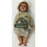 A 1920's bisque doll with removable clothes, red hair