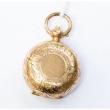A gilt metal sovereign case, round form with scroll and foliate engraved decoration, plain