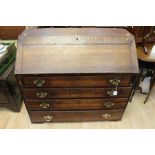 A George III oak bureau, circa 1800, the fall front enclosing a fitted interior of drawers and