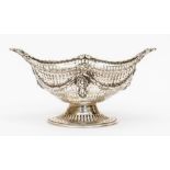A Neo-Classical style navette shaped bon bon dish, rocaille and dart border above galleried body