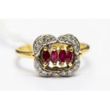 A ruby and diamond 18ct gold ring, comprising marquise rubies set to the centre withing a